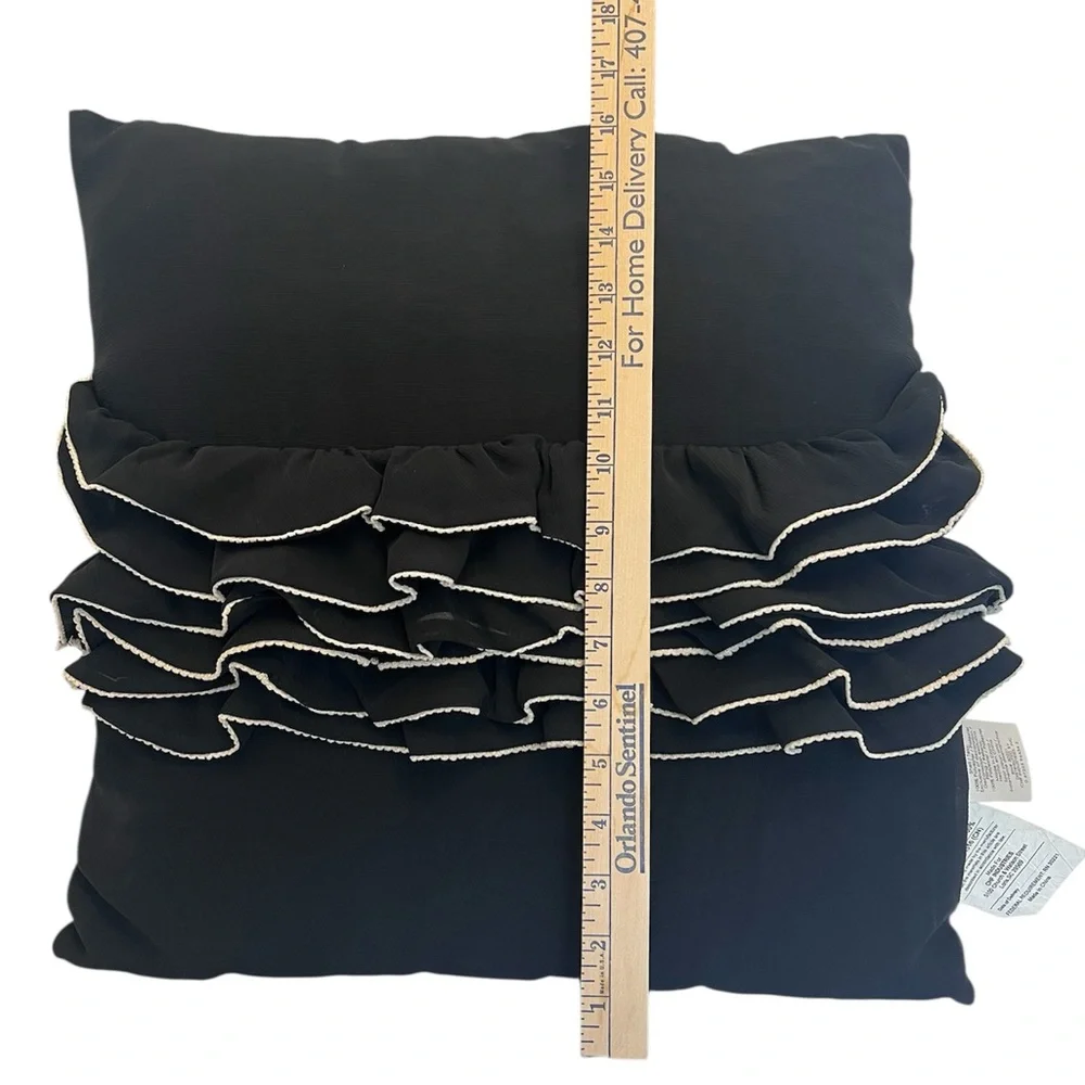 Elegant Black and Cream Ruffled Throw Pillow by Daisy Fuentes.
